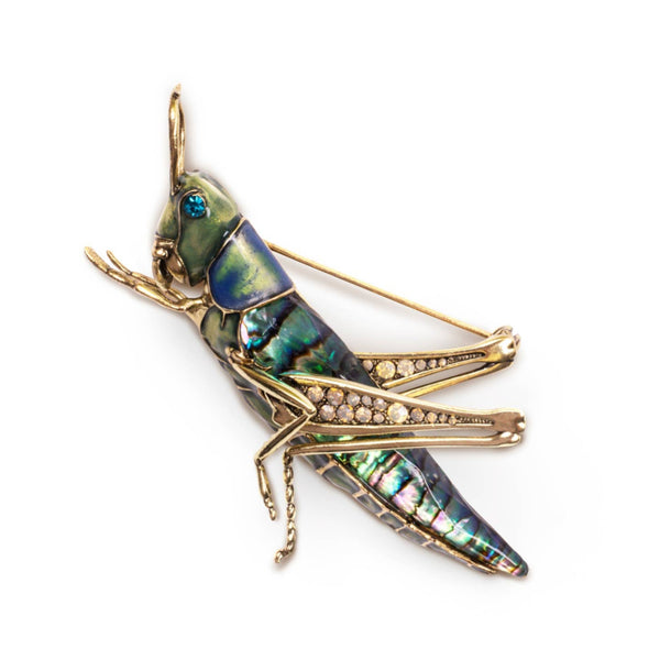 Close-up of Bill Skinner Grasshopper Brooch with iridescent enamel finish