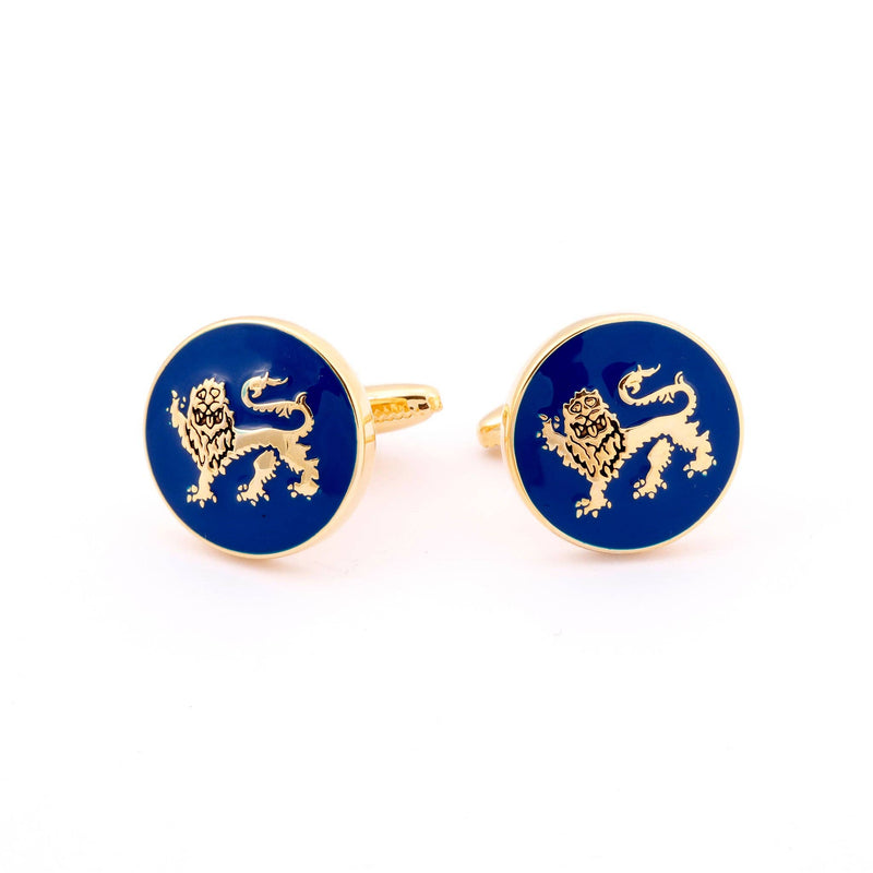 Close-up of Lion Passant Guardant Gold Cufflinks showing detailed lion design on blue enamel background.