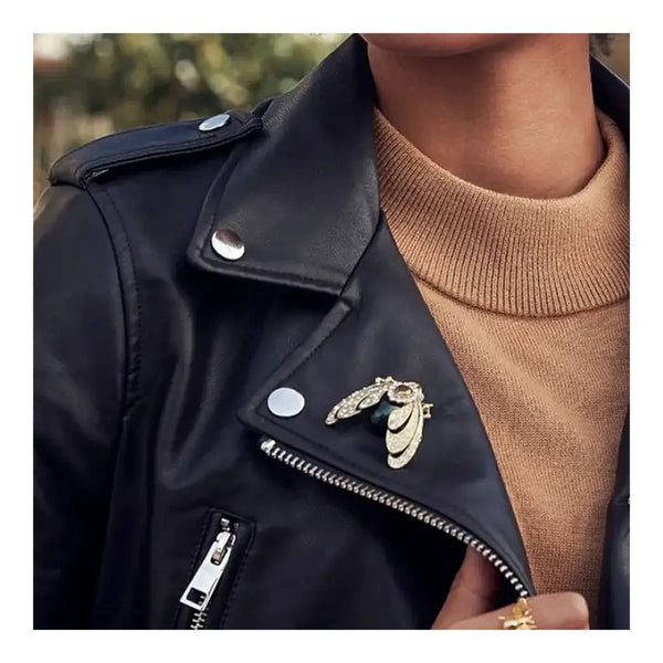 Moth brooch worn on black jacket, styled as statement accessory