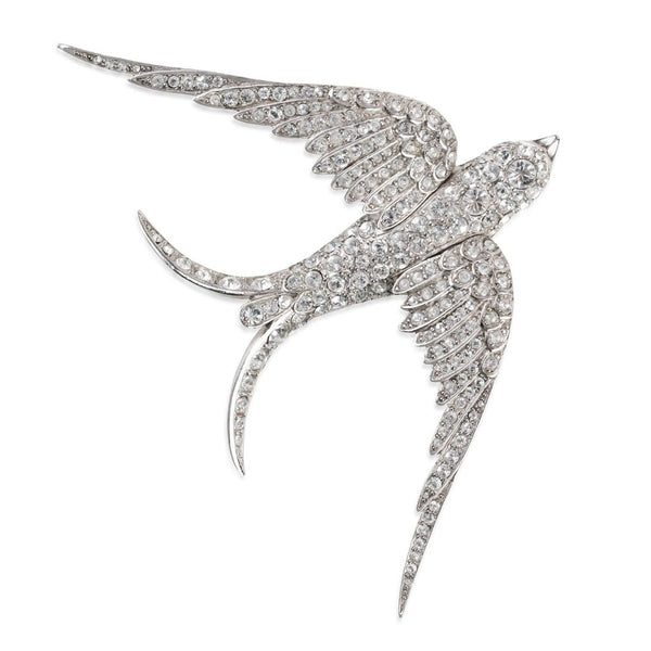 Close-up of Pave Swallow Brooch by Bill Skinner with sparkling crystals in antique gold finish.