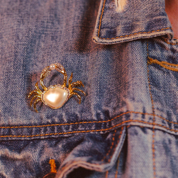 Pearly Crab Brooch by Bill Skinner worn on denim jacket for a fun, fashionable look.