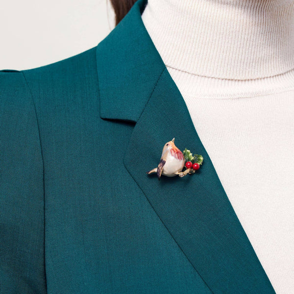 Robin Brooch by Bill Skinner pinned on teal jacket lapel, showcasing size and festive styling