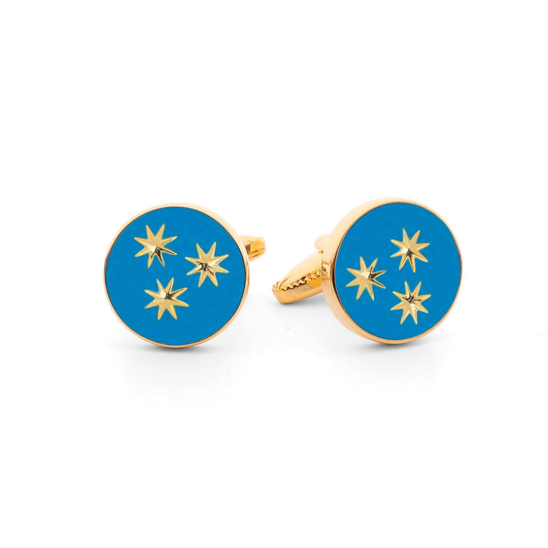 Close-up of St Philip Neri Cufflink showcasing light blue enamel with three golden stars.