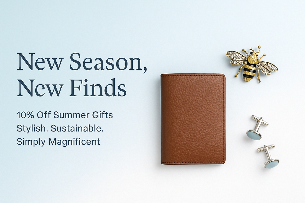 Brown leather wallet, silver cufflinks, and bee brooch displayed on a light blue background with text "New Season, New Finds – 10% Off Summer Gifts" for Simply Magnificent’s summer collection.